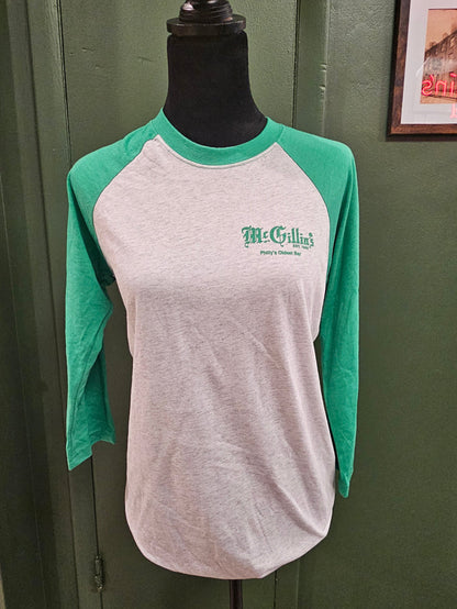 Green and white apron with 'McGrillin's' logo on a green surface
