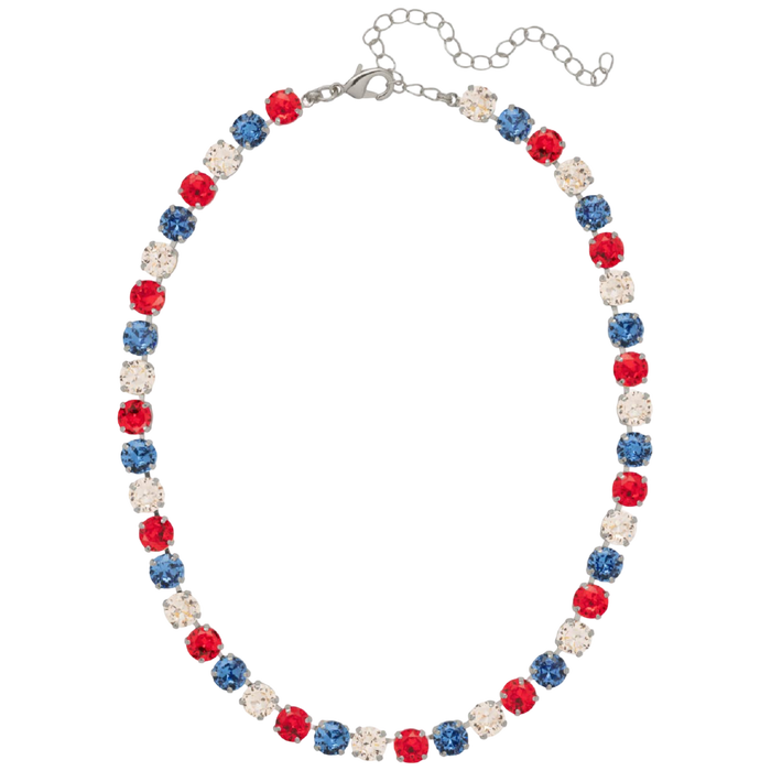 A patriotic beaded necklace featuring alternating red, blue, and clear rhinestone beads on a silver-tone chain with an extender clasp, shown against a plain white background.