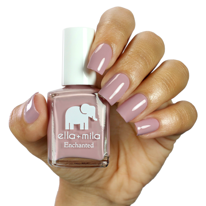 Spellbound pink lilac nail polish manicure on a light skin tone with the bottle