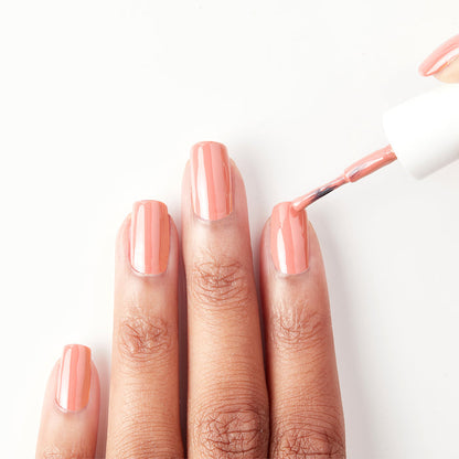 Applying Sugar Rush bright peachy pink nail polish