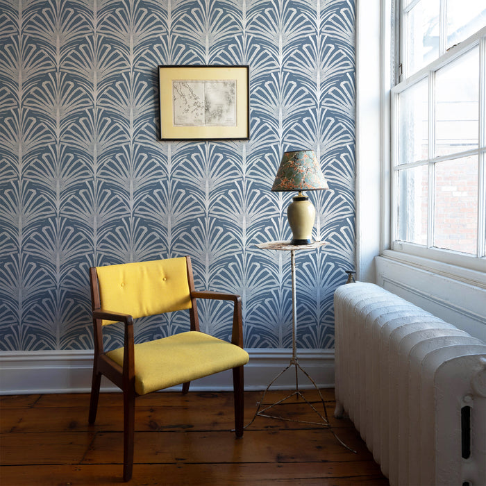 Cozy corner with Suzy Steel wallpaper in soft gray botanical pattern, paired with yellow chair, made-to-order, USA-made.