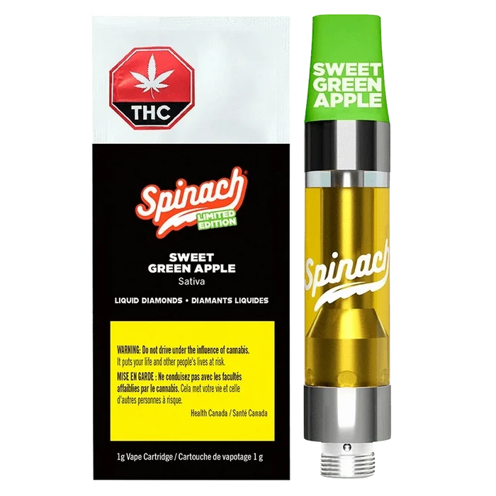 Right-side view of the Sweet Green Apple Liquid Diamonds Vape Cartridge by Spinach, showing the green cap, golden liquid chamber, and black-and-white branded box beside it.