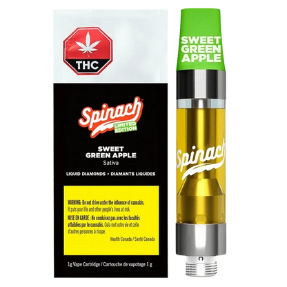 Right-side view of the Sweet Green Apple Liquid Diamonds Vape Cartridge by Spinach, showing the green cap, golden liquid chamber, and black-and-white branded box beside it.