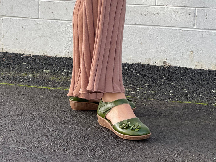 Smart green sandal in soft leather uppers. Velcro strap, wedge sole unit with enclosed heel and enclosed toe. Comfortable women's sandal with floral detail. Women's shoes with cushioned footbed.