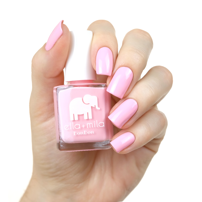 Team Sweets light baby pink nail polish manicure on a light skin tone with the bottle