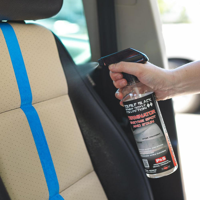 A person spraying a leather car seat with P & S Terminator.