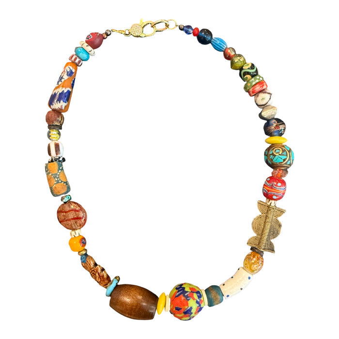 A beaded necklace featuring a variety of colorful, patterned, and textured beads in orange, blue, yellow, red, and brown, with a gold-tone clasp, shown on a plain white background.