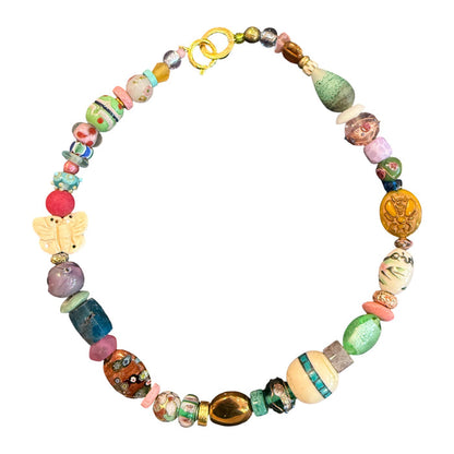 A handmade beaded necklace featuring a variety of colorful, textured glass and wooden beads, including a butterfly charm and a gold clasp, displayed on a clean white background.