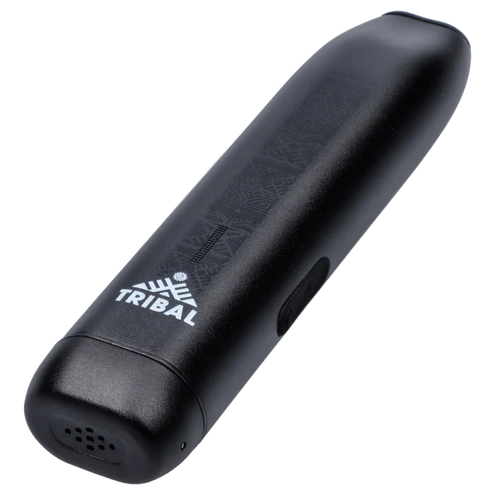 Angled close-up of the black Tribal Aerolith Dry Herb Vaporizer showing its textured top surface, white TRIBAL logo, and side power button.