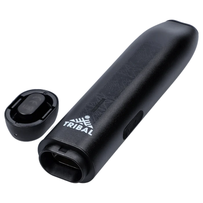 Angled close-up of the black Tribal Aerolith Dry Herb Vaporizer showing its embossed pattern, white TRIBAL logo, mouthpiece opening, and detached magnetic cap.