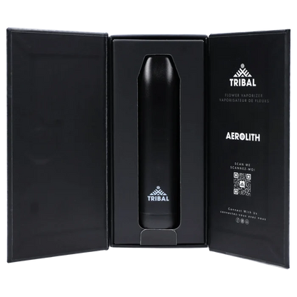 Center view of the black Tribal Aerolith Dry Herb Vaporizer nestled upright in its open black presentation box with printed logo and QR code on the right panel.