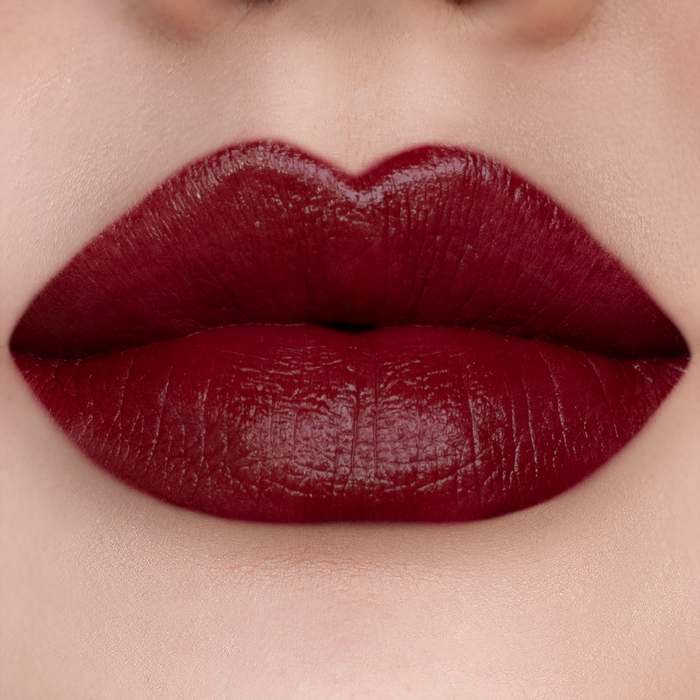 Vampy deep red lipstick on lips, light skin tone