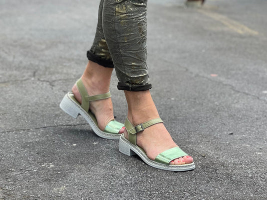 Woman's green chunky sole sandal with a buckle fastening. Buckle up ankle strap, lightweight and cushioned footbed.